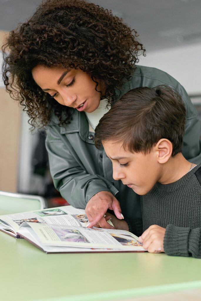 Woman helping a child with his homework, symbolizing learning support, guidance, and parent-child connection. Therapy for academic stress in blaine mn