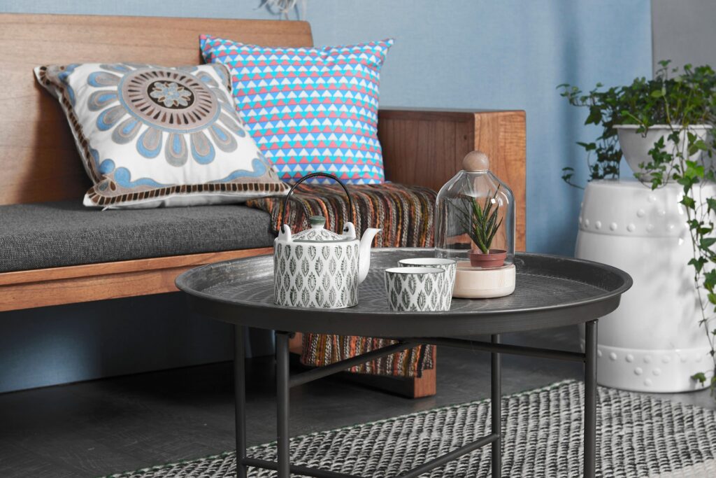 Coffee table in front of a bench with a teapot and cup, symbolizing warmth, coziness, and peaceful environment Therapy Payment At Kindred Counseling Blaine MN