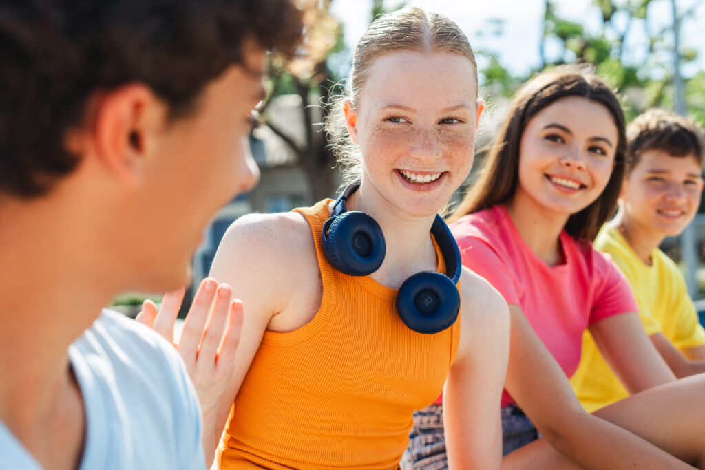 Therapy for teens in Blaine MN. Girl talking to a boy with her friends.