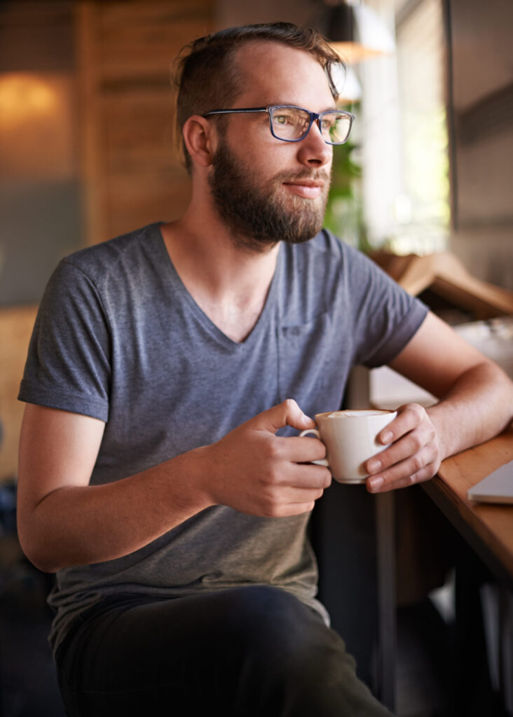 Man sitting with a cup of coffee. Therapy for trauma in Blaine MN