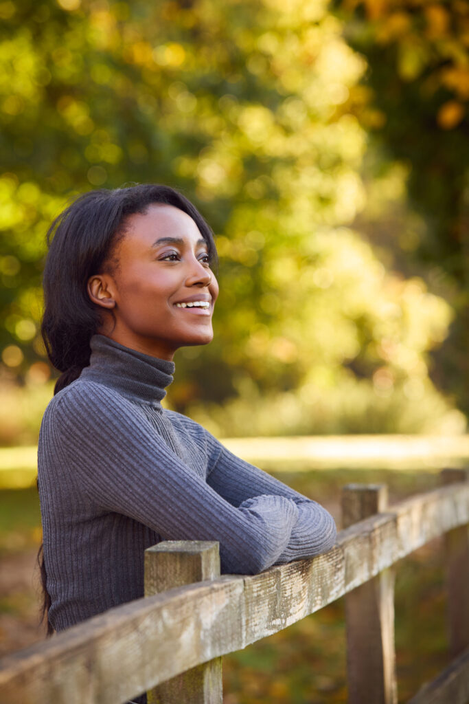 Young woman standing on a bridge. Therapy for self esteem in Blaine MN