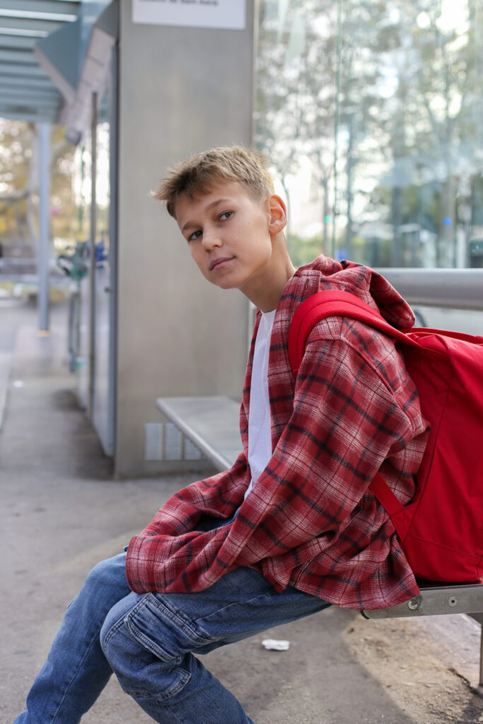 Teenage Boy waiting with backpack. Therapy for teens in Blaine MN