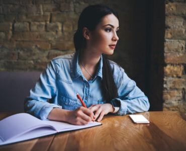 Therapy for intrusive thoughts in Blaine MN. Girl writing in a notebook.