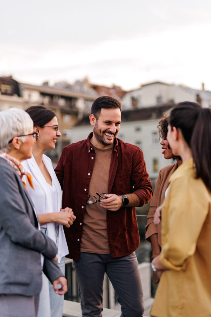 Therapy in Blaine MN . Man standing amogst friends