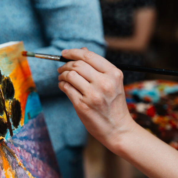 Therapist in Blaine MN Person painting a landscape.