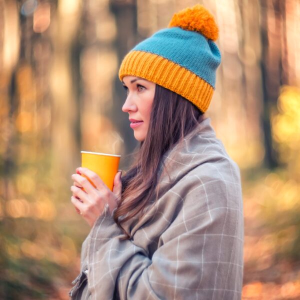 beautiful-woman-in-a-knitted-hat-drinking-tea-in-a-2026-01-05-01-11-27-utc