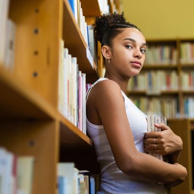 Black african american young girl student studying at the school university library