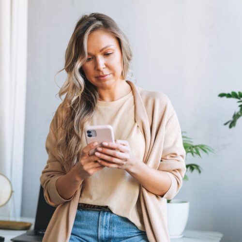 blonde-business-woman-using-mobile-phone-near-wind-2026-01-05-05-35-18-utc