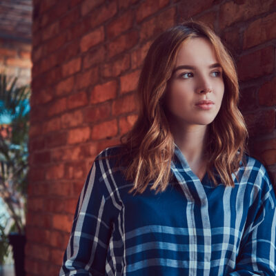 A young charming sexy girl in a room with a loft interior.