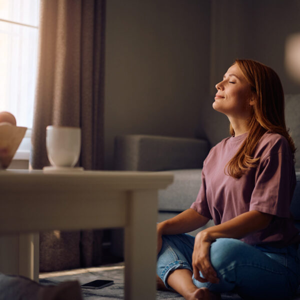 Therapy in Blaine MN. Woman meditating on the floor.