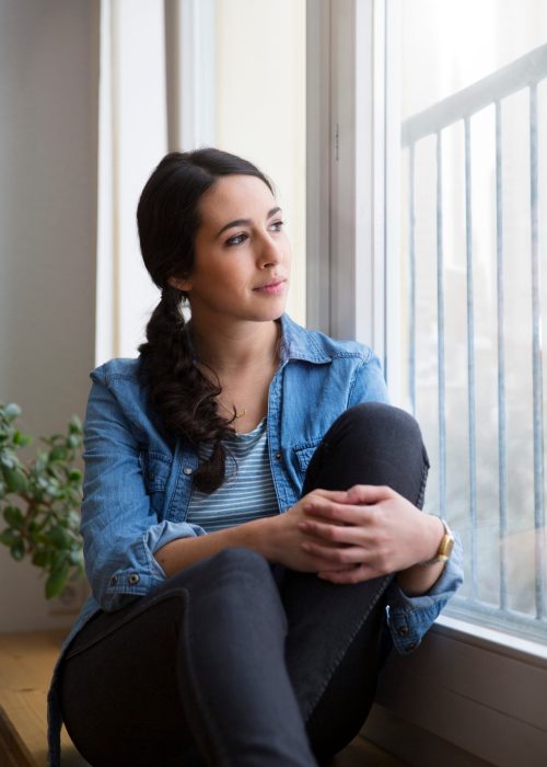 Therapy for anxiety in blaine mn . Woman staring out the window.