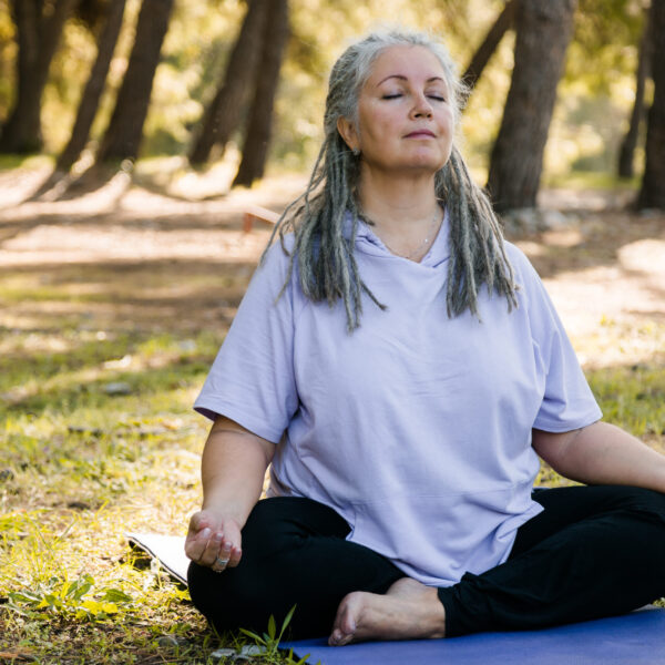 Woman meditating in the grass. Therapy services in Blaine MN