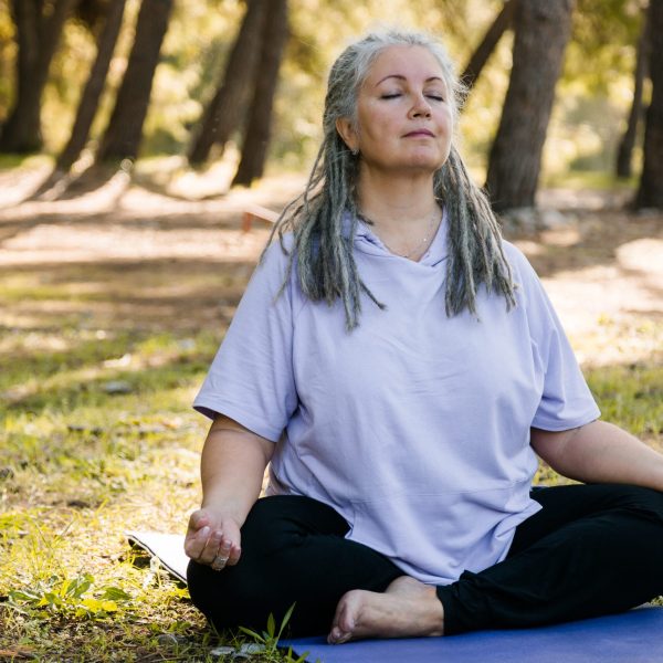 Woman meditating in the grass. Therapy services in Blaine MN