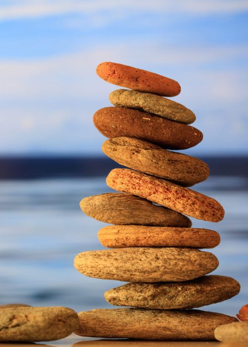 Harmony, balance in nature. Zen stones stack on blue sky and sea background